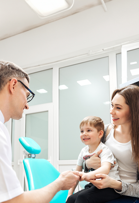 Mother taking her baby to their first dental checkup